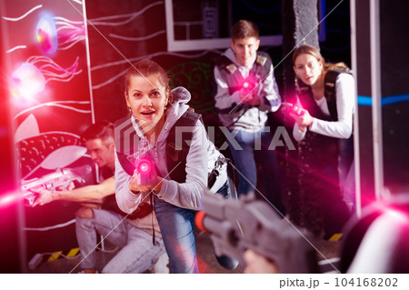 Excited girl during lasertag game Excited girl during lasertag game 104168202