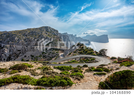 Winding narrow road to lighthouse at Cape Formentor in the Coast of North Mallorca, Spain Winding narrow road to lighthouse at Cape Formentor in the Coast of North Mallorca, Spain 104168890