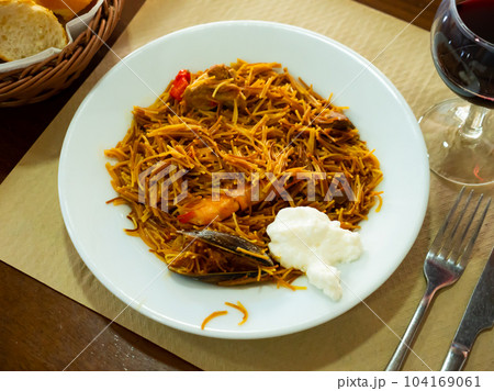Spanish seafood fideua, noodle paella with aioli Spanish seafood fideua, noodle paella with aioli 104169061