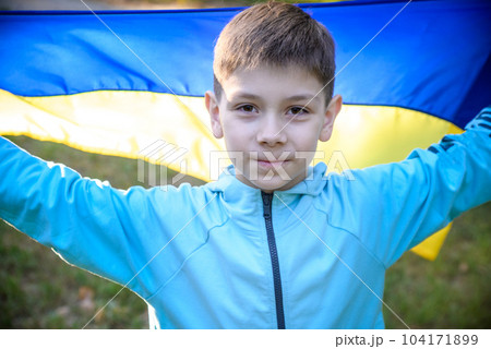 Pray for Ukraine. boy with Ukrainian flag running the summer par 104171899