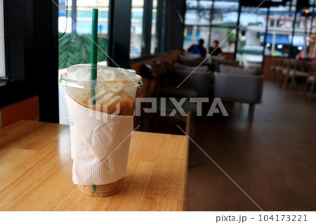 Ice coffee on wood table in shop. Ice coffee on wood table in shop. 104173221