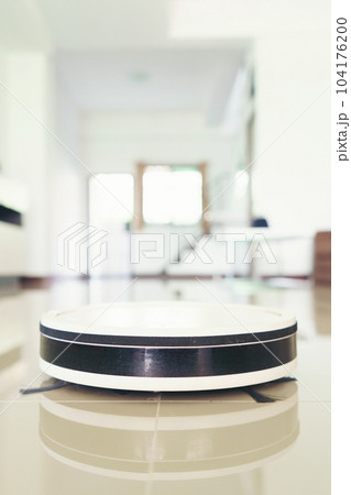 vacuum cleaning robot cleaning the room. vacuum cleaning robot cleaning the room. 104176200