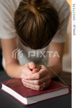 Christian Woman Hands Folded On Holy Bible Are Pray And Worship 104177576