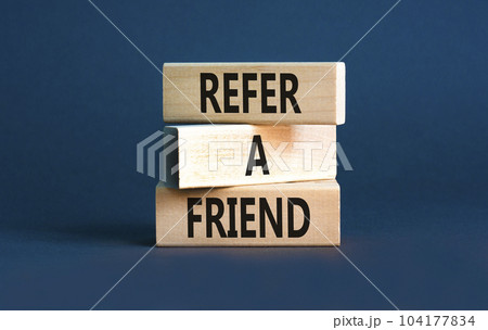Refer a friend symbol. Concept words Refer a friend on wooden blocks on a beautiful grey table grey background. Business and refer a friend concept. Copy space. 104177834