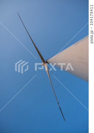Bottom view of a windmill against a blue sky. Alternative energy source. 104178411