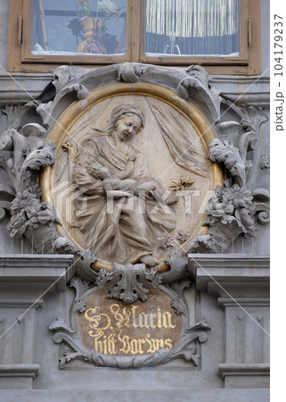 Virgin Mary with baby Jesus, statue on the house facade in Graz, Styria, Austria Virgin Mary with baby Jesus, statue on the house facade in Graz, Styria, Austria 104179237
