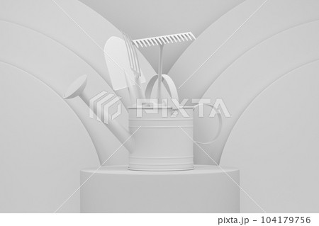 Watering can with garden tools on cylinder podium with step on monochrome 104179756