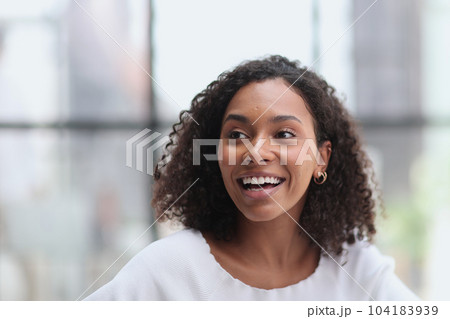 Happy business woman smiling inside office building Happy business woman smiling inside office building 104183939
