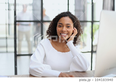 Portrait of a confident businesswoman with team in the background 104183940