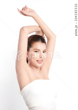 Beautiful Young Asian woman lifting hands up to show off clean and hygienic armpits or underarms on white background, Smooth armpit cleanliness and protection concept 104185310