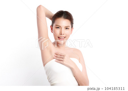 Beautiful Young Asian woman lifting hands up to show off clean and hygienic armpits or underarms on white background, Smooth armpit cleanliness and protection concept 104185311