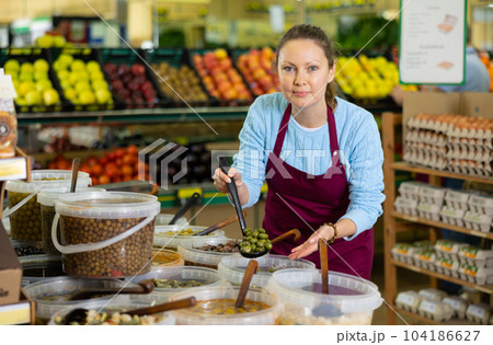 woman seller offers to buy olives 104186627