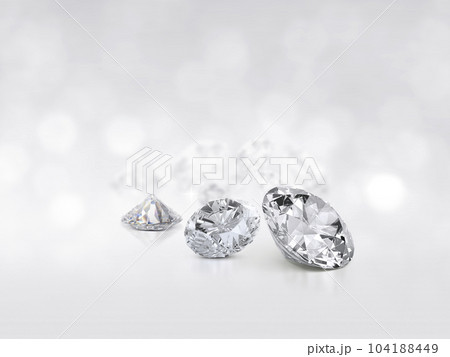 still with expensive cut diamonds in front of a white background, reflections on the ground. Lot of copy space 104188449