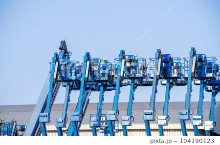 Articulated boom lift. Aerial platform lift. Telescopic boom lift against clear sky. Mobile construction crane for rent and sale. Maintenance and repair hydraulic boom lift service. Crane dealership. 104190123