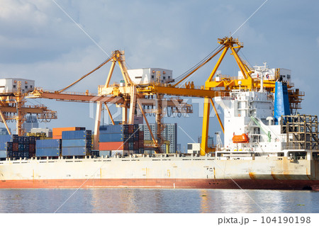 Cargo ship at dock with sky background. 104190198