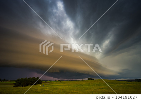Angry supercell storm influenced by Climate change. Dangerous storm supercell shelf cloud with layers. 104191027