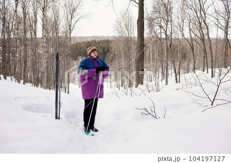 Portrait of a senior skier in a winter forest 104197127