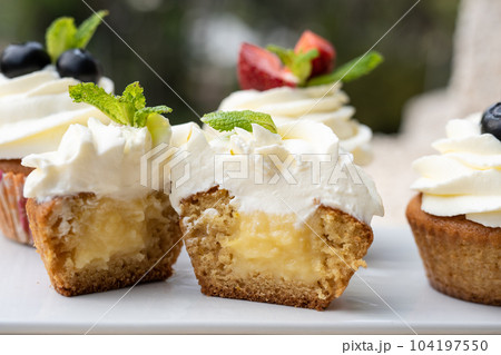Cupcakes with different fruits on a white plate close-up. Cupcakes with different fruits on a white plate close-up. 104197550