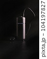 powerbank black on a black background, usb cable, plug, light and reflection 104197827