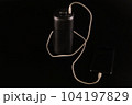 powerbank black on a black background, usb cable, smartphone, plug, light and reflection 104197829