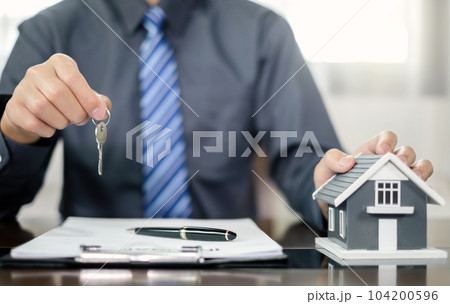 Agents working in real estate investment and home insurance signing contracts in accordance with the home buying insurance agreements approving purchases for clients 104200596