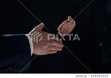 Close-up image of handshake between two colleagues. Close-up image of handshake between two colleagues. 104201024