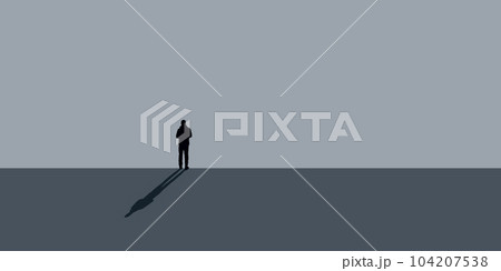 lonely man stands in front of a gray wall shadow 104207538