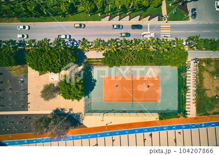 Aerial view of tennis court and motorway 104207866