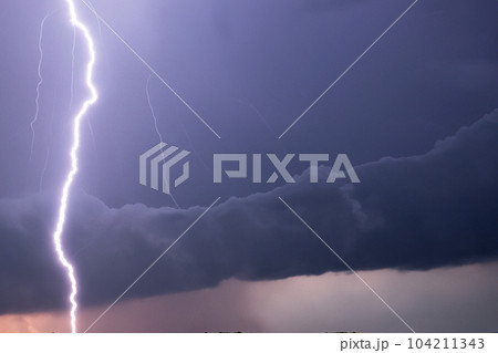 Ray. Lightning storm. Lightning bolt storm. Fork lightning striking. Lightning thunderstorm flash over the night sky. Concept on topic weather, cataclysms (hurricane, Typhoon, tornado, storm). 104211343