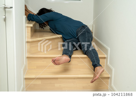 Asian lady fall down the stairs and pain at hip and waist because slippery surfaces. 104211868