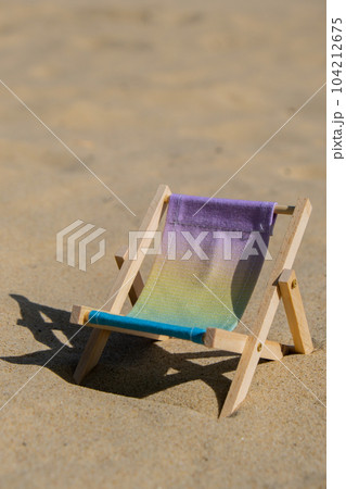 Sunny holidays on the beach sand beach accessories. Sun lounger stand sea. Wooden beach chairs. Summer holiday vacation concept. Copy space Sunny holidays on the beach sand beach accessories. Sun lounger stand sea. Wooden beach chairs. Summer holiday vacation concept. Copy space 104212675