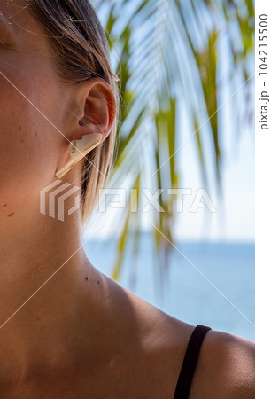 Gentle lifestyle female portrait, close up. Tropical summer mood. Gentle lifestyle female portrait, close up. Tropical summer mood. 104215500