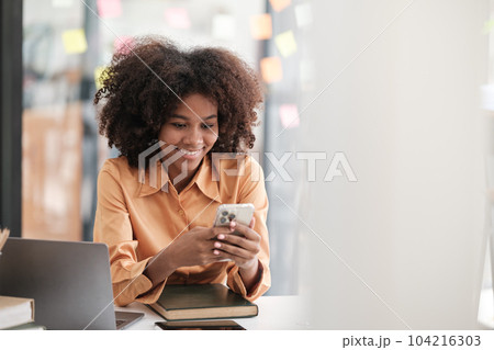 African American female employee write down on colorful sticky notes manage list, concentrated biracial woman work on startup brainstorm collaborate plan on stickers on glass wall African American female employee write down on colorful sticky notes manage list, concentrated biracial woman work on startup brainstorm collaborate plan on stickers on glass wall 104216303