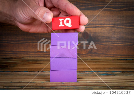 IQ Test Concept. Colorful blocks on a wooden texture background 104216337