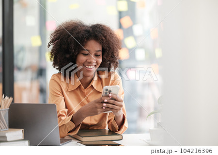 African American female employee write down on colorful sticky notes manage list, concentrated biracial woman work on startup brainstorm collaborate plan on stickers on glass wall African American female employee write down on colorful sticky notes manage list, concentrated biracial woman work on startup brainstorm collaborate plan on stickers on glass wall 104216396
