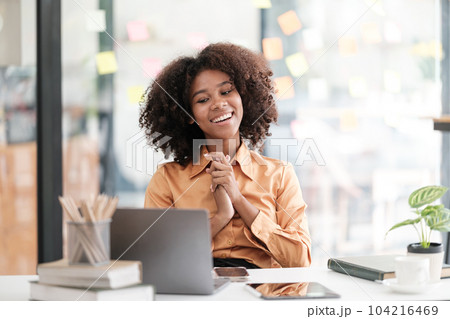 African American female employee write down on colorful sticky notes manage list, concentrated biracial woman work on startup brainstorm collaborate plan on stickers on glass wall 104216469