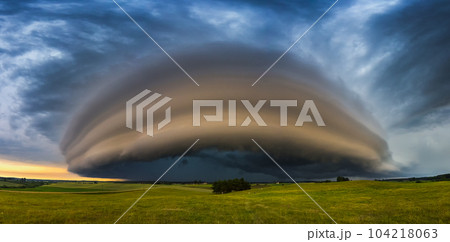 Angry supercell storm influenced by Climate change. Dangerous storm supercell shelf cloud with layers. 104218063