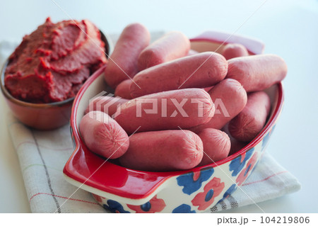 Mini Sausage in a red color bowl on white Mini Sausage in a red color bowl on white 104219806