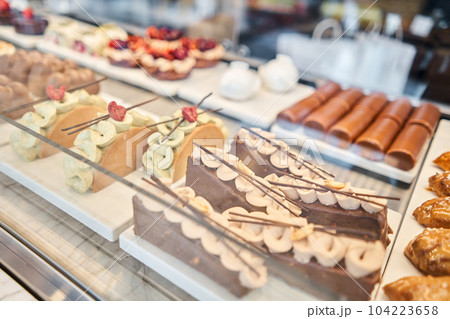 fresh pastries with berries. A variety of fresh pastries in the bakery window. almond croissant is fresh and hot in a cafe next to other types of pastries. The interior of an Italian restaurant. fresh pastries with berries. A variety of fresh pastries in the bakery window. almond croissant is fresh and hot in a cafe next to other types of pastries. The interior of an Italian restaurant. 104223658
