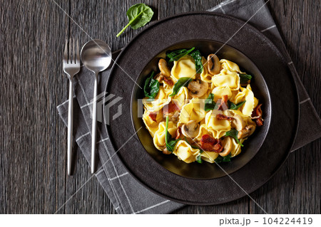 hot tortellini with mushrooms, spinach and bacon hot tortellini with mushrooms, spinach and bacon 104224419