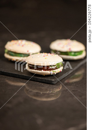 Vanilla macaron with rainbow ganache 104226778