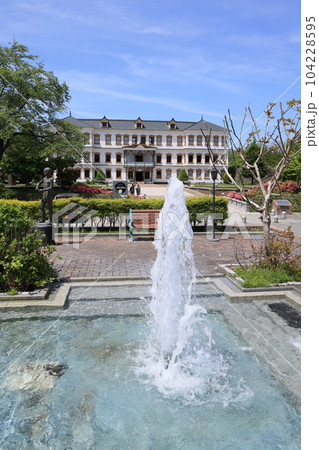 前景に噴水を入れた小坂鉱山事務所の写真です。 104228595