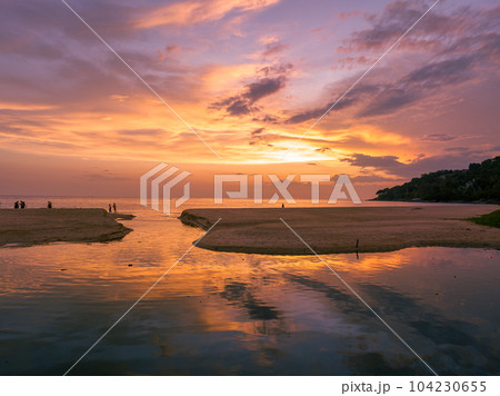 .aerial view stunning reflection of bright golden sky in a canal at Karon beach Phuket. 104230655