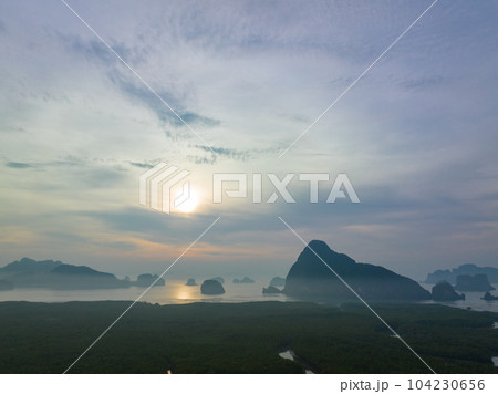 aerial view Amazing light of nature cloudscape sky above Samed Nang Chee Phang Nga archipelago. .Imagine a fantasy bright red sky at sunrise from a bird's eye view..tropical landscape background. aerial view Amazing light of nature cloudscape sky above Samed Nang Chee Phang Nga archipelago. .Imagine a fantasy bright red sky at sunrise from a bird's eye view..tropical landscape background. 104230656