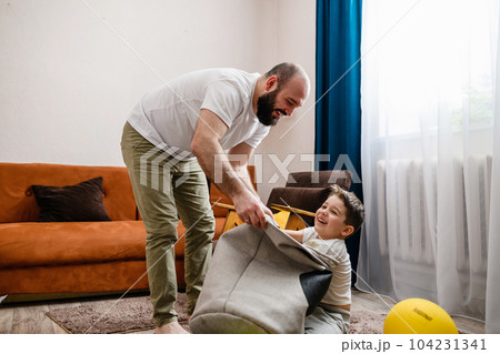 Happy father and son play together home Happy father and son play together home 104231341
