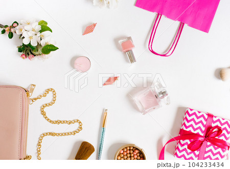 Concept of a beauty blog. Accessories for women's makeup and delicate apple blossoms on a white background. Flat apartment, top view, women's desk, workplace Concept of a beauty blog. Accessories for women's makeup and delicate apple blossoms on a white background. Flat apartment, top view, women's desk, workplace 104233434