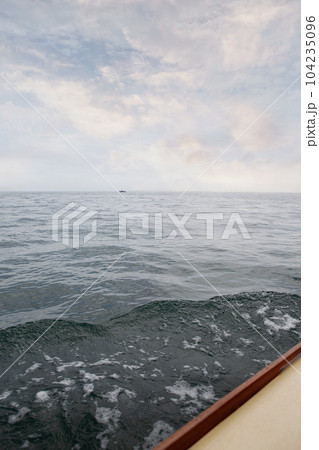 Watch the ocean from the deck of a boat 104235096