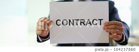 Hands of businessman holding contract document for employment at work in office closeup 104237860