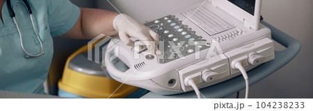 Veterinarian presses key on control panel of ultrasound machine at investigation in clinic Veterinarian presses key on control panel of ultrasound machine at investigation in clinic 104238233