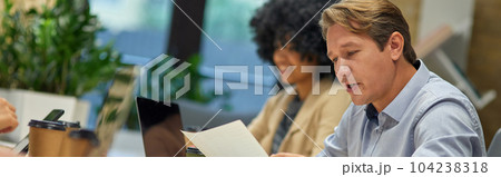 Two diverse coworkers working together in the modern office 104238318